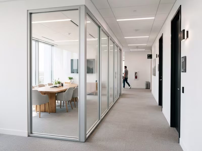 Daylight passing through glass meeting room walls Daylight passing through glass meeting room walls