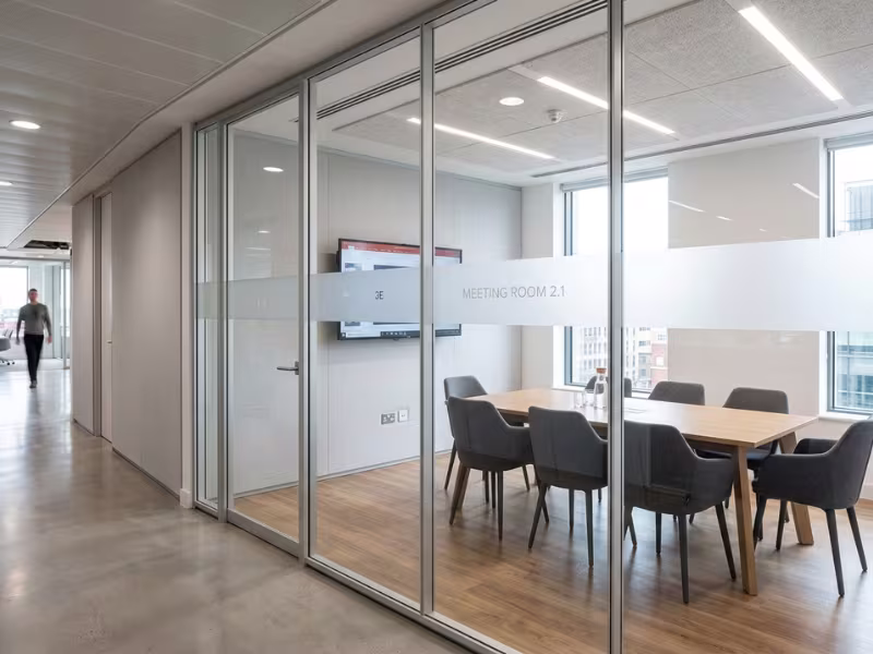 Meeting room with glazed front and solid side walls Meeting room with glazed front and solid side walls