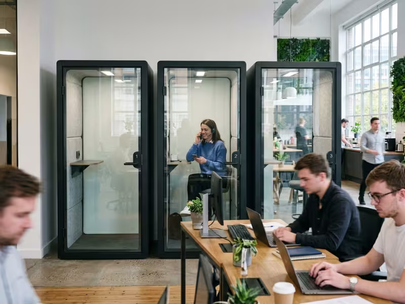 Phone booths in a busy open office Phone booths in a busy open office